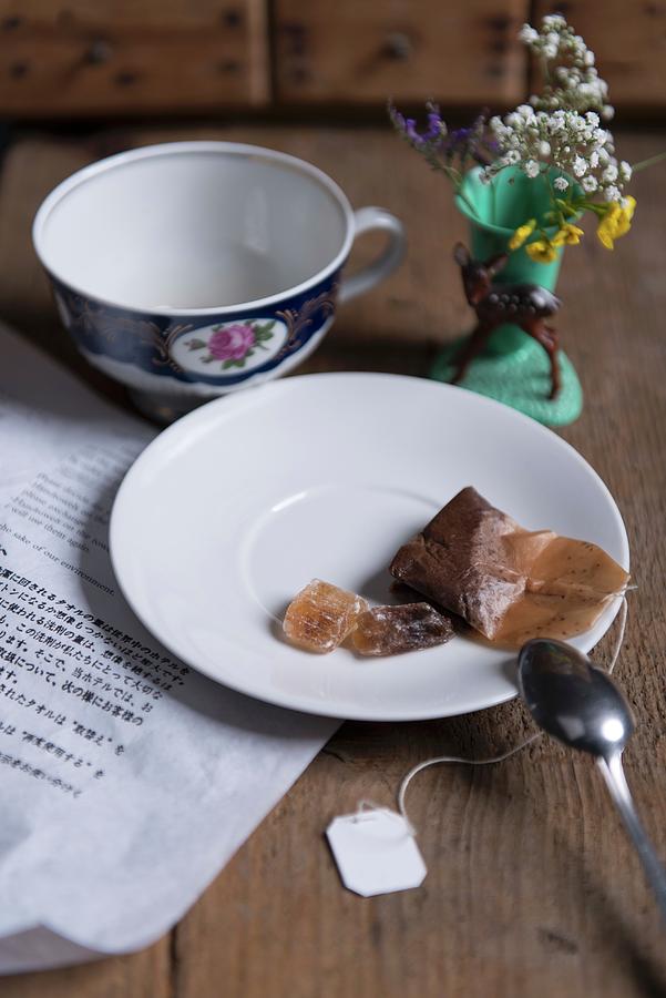 A Used Tea Bag And Rock Sugar On A Saucer Next To A Tea Cup Photograph by Angelika Grossmann