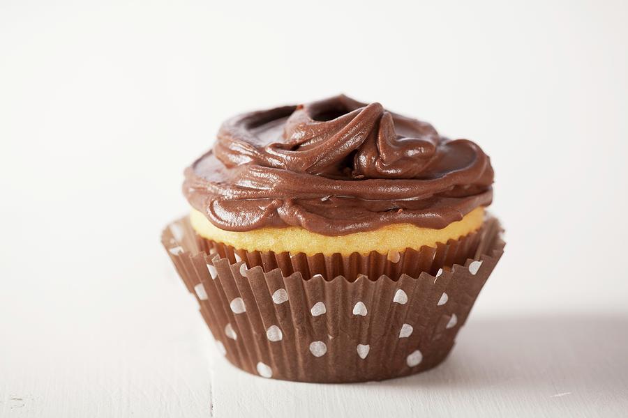 A Vanilla Cupcake With Chocolate Frosting Photograph by John Gagne