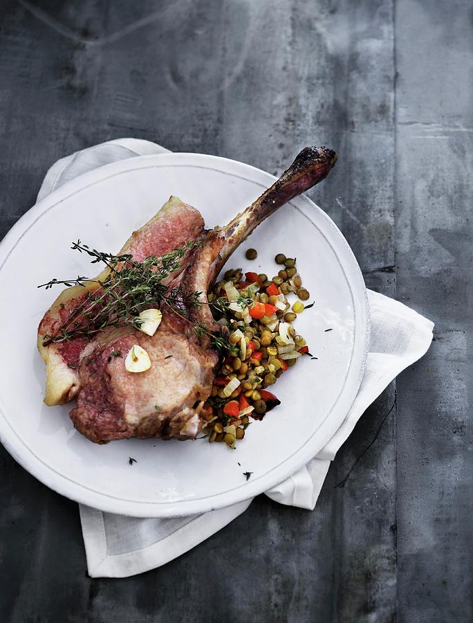 A Veal Chop With Thyme On A Lentil Medley Photograph by Mikkel Adsbl