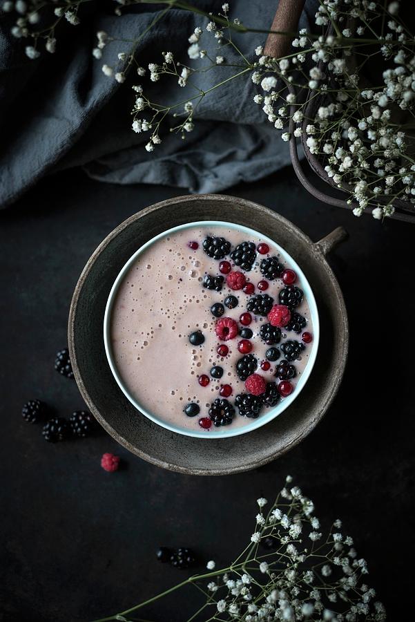A Vegan Banana And Raspberry Smoothie Bowl Topped With Blackcurrants, Raspberries And Redcurrants Photograph by Kati Neudert