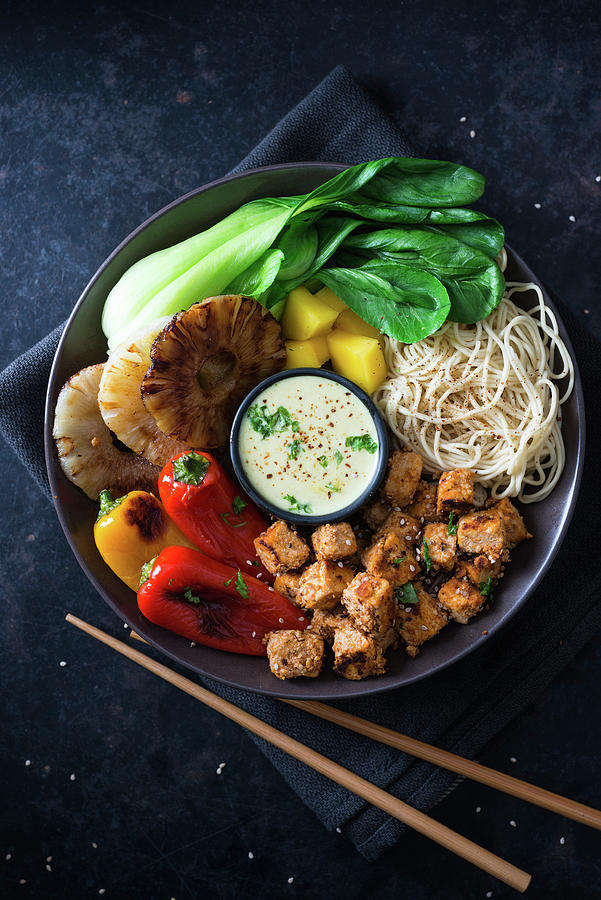 A Vegan Buddha Bowl With Mie Noodles, Mango, Pineapple, Bok Choy, Grilled Peppers, Tofu And Coconut Curry Sauce asia Photograph by Kati Neudert