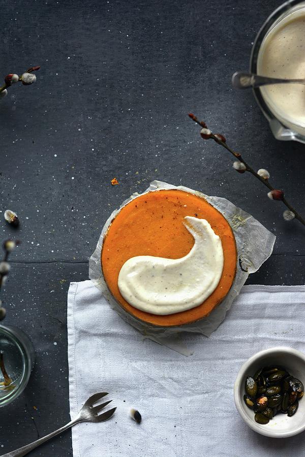 A Vegan Pumpkin Cake With Cashew Cream And Caramelised Pumpkin Seeds Photograph by Pilar Felix