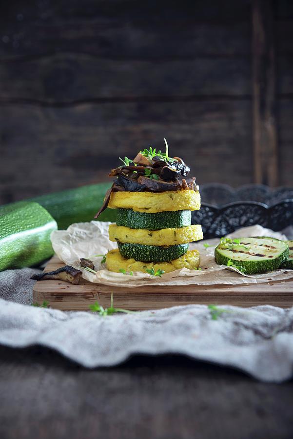 A Vegan Tower Made Of Polenta Rounds And Slices Of Courgette With Porcini Mushrooms Photograph by Kati Neudert