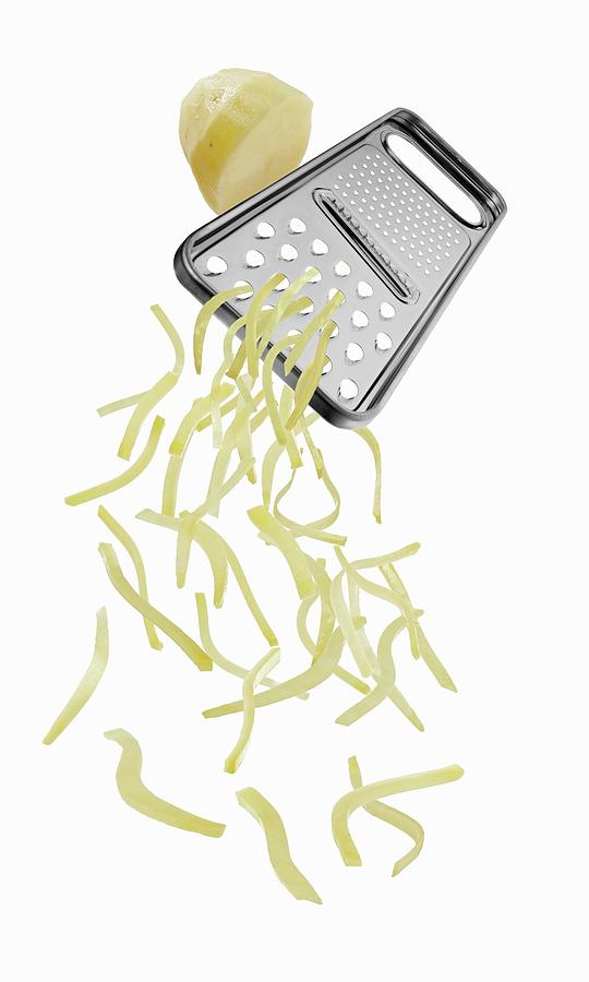 A Vegetable Grater With Grated Potato Photograph by Krger & Gross