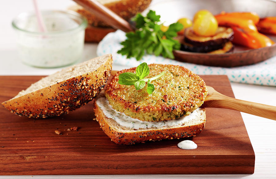 A Vegetarian Quinoa Burger With Yoghurt Sauce And Roasted Vegetables Photograph by Teubner Foodfoto