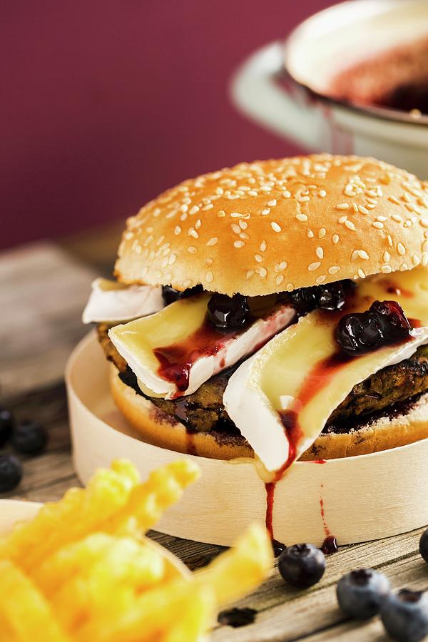 A Veggie Burger With A Bean Patty, Camembert And A Blueberry And Balsamic Chutney Photograph by Sandra Krimshandl-tauscher