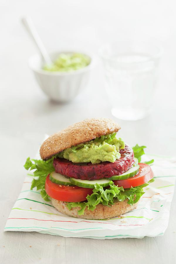A Veggie Burger With A Beetroot Patty And Avocado Spread Photograph by Olga Miltsova