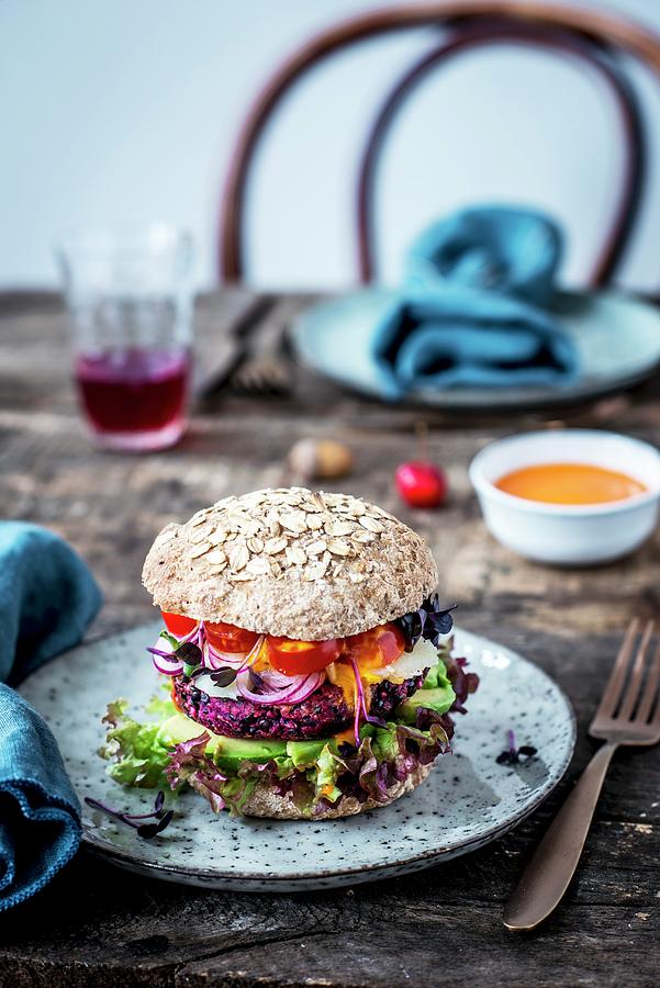 A Veggie Burger With Wholegrain Bread, Lentils, Avocado, Sheeps Cheese And Tomatoes Photograph by Carolin Strothe