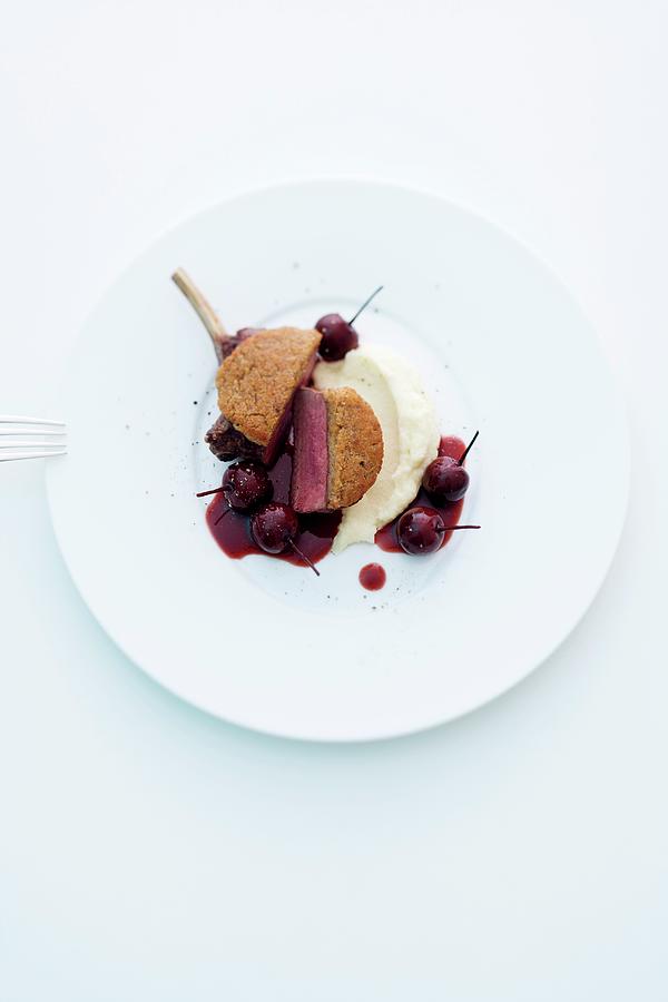 A Venison Chop With A Chestnut Crust On A Bed Of Mashed Celeriac And Port Wine Cherries Photograph by Michael Wissing