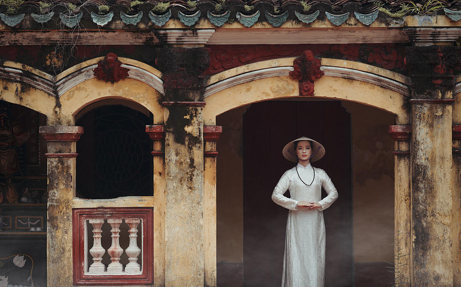 Architecture Photograph - A Vietnamese Girl In A Traditional Ao Dai Dress Is Praying For Happiness by Vu Thien Vu