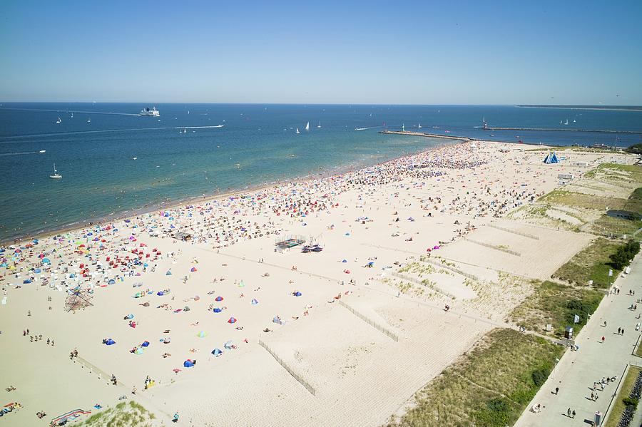 Beach Photograph - A View From Hotel Neptun Of The Popular Beach And The Entrance To The Harbour At Warnemnde by Jalag / Natalie Kriwy