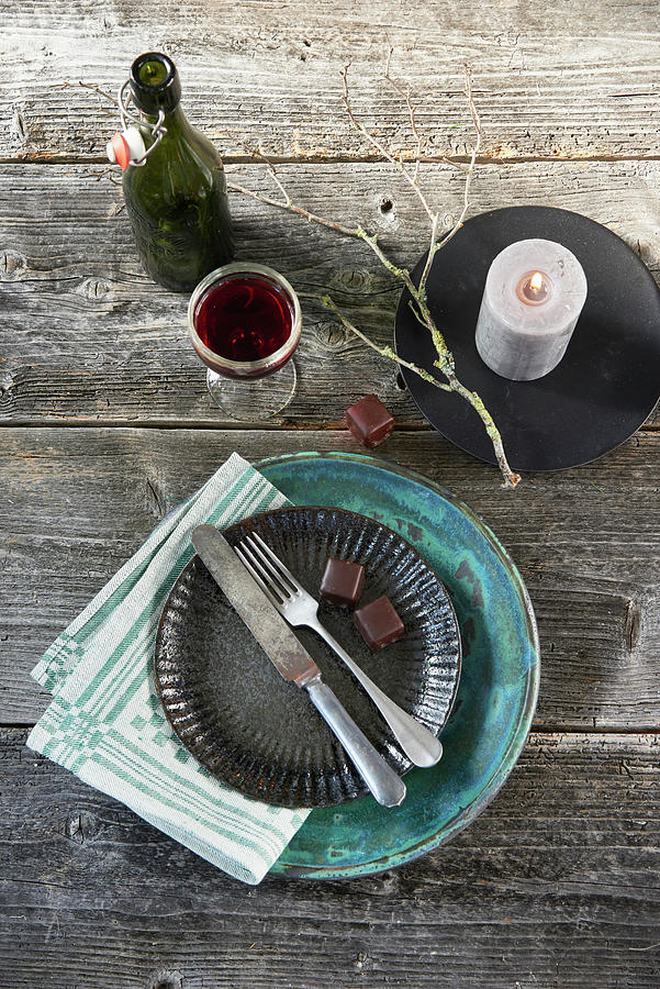 A Vintage Place Setting With Two Chocolate Covered Marzipan And Gingerbread Sweets, A Candle And Red Wine Photograph by Inge Ofenstein