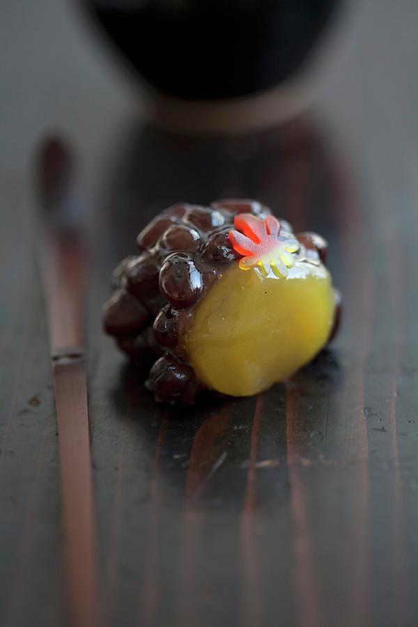 A Wagashi Grape Made From Kidney Beans And Chestnut Paste Photograph by Martina Schindler