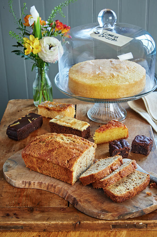 A Walnut Cake And A Lemon Drizzle Cake On A Cake Buffet Photograph by William Reavell