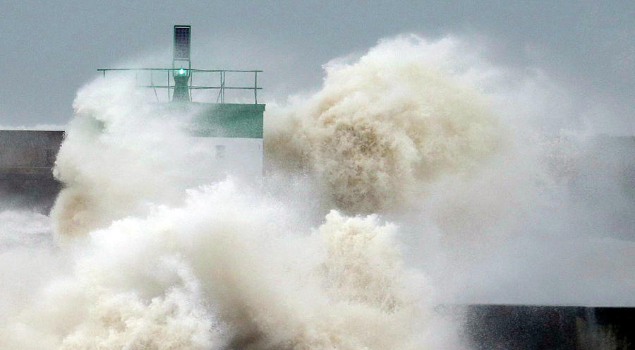 A Wave Breaks Near the Lighthouse Photograph by Regis Duvignau - Fine ...