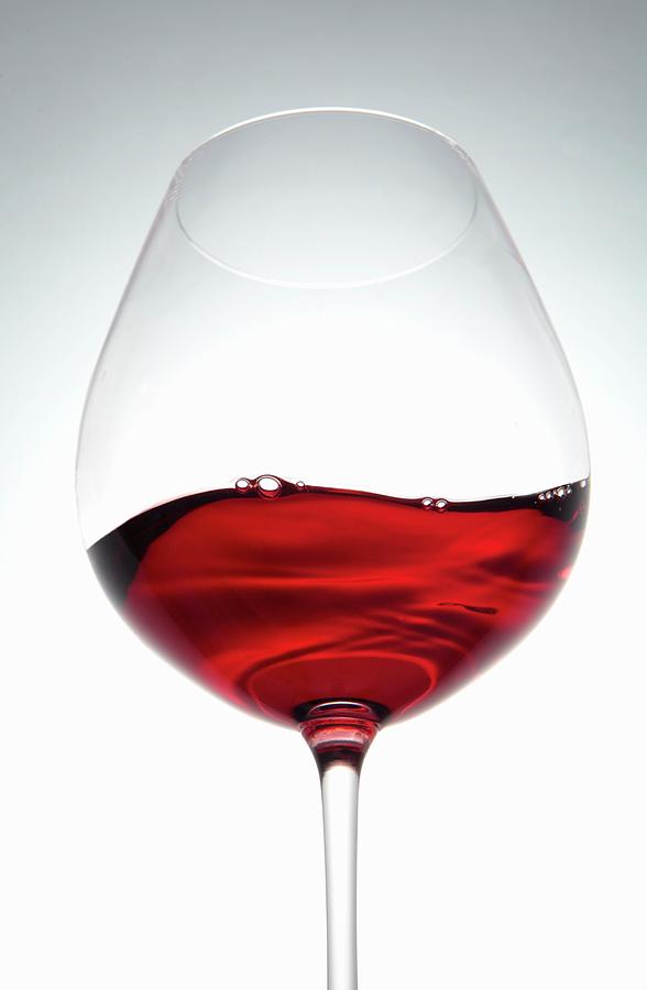 A Wave Of Red Wine In A Glass Photograph by Peter Garten