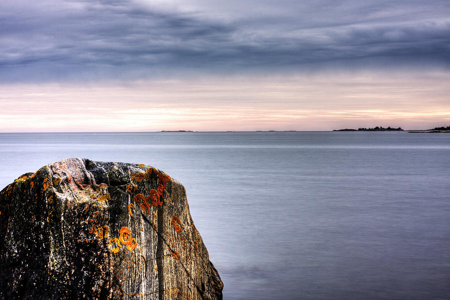 A Weathered Rock In The Sea Under A Photograph by Johan Klovsjö