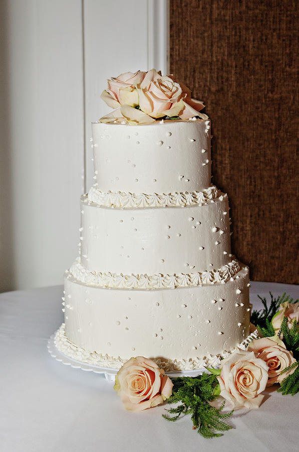 A Wedding Cake Trimed In Peach Roses Photograph by Driendl Group