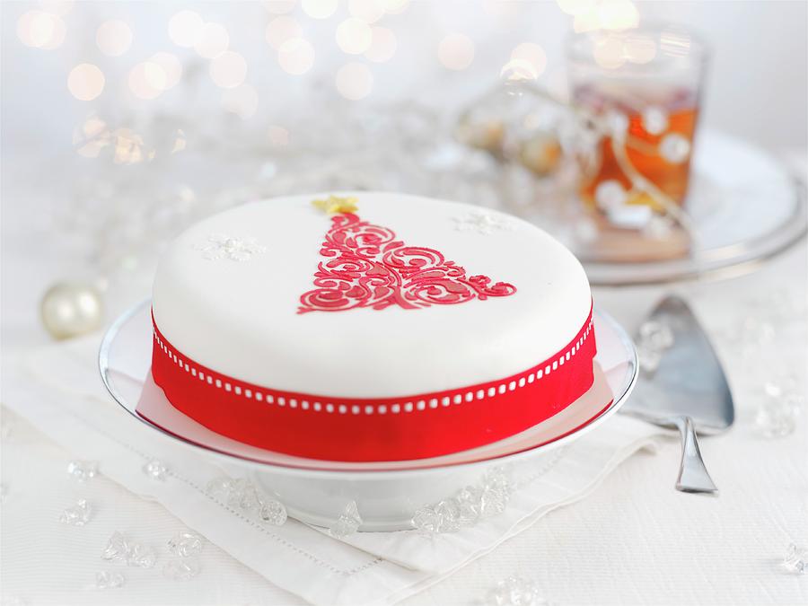 A White Christmas Cake Decorated With A Red Christmas Tree Photograph by Ian Garlick