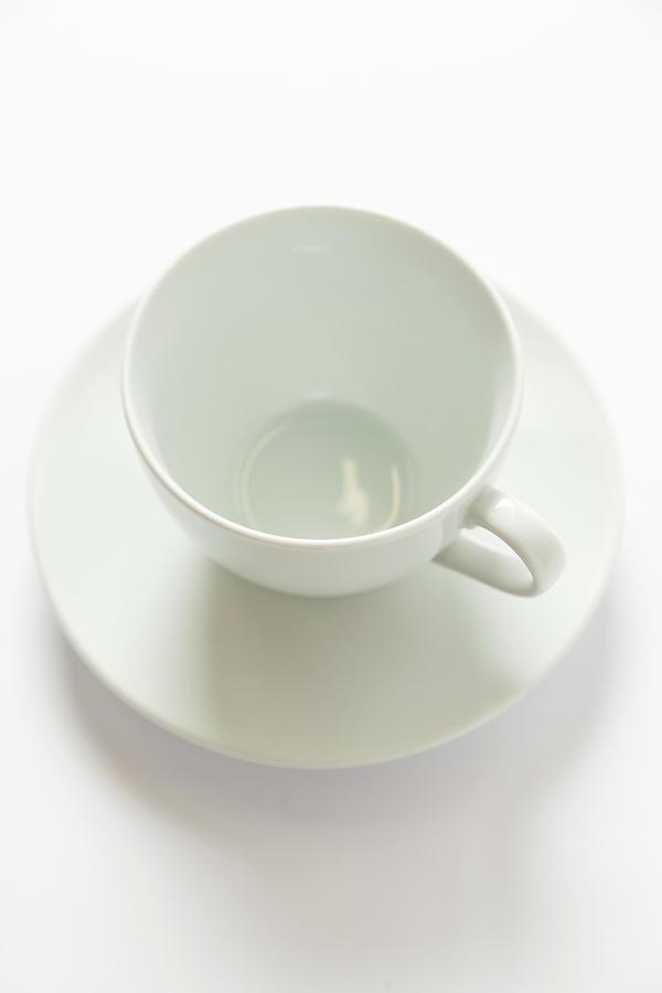 A White Cup And Saucer Photograph by Geoff Fenney