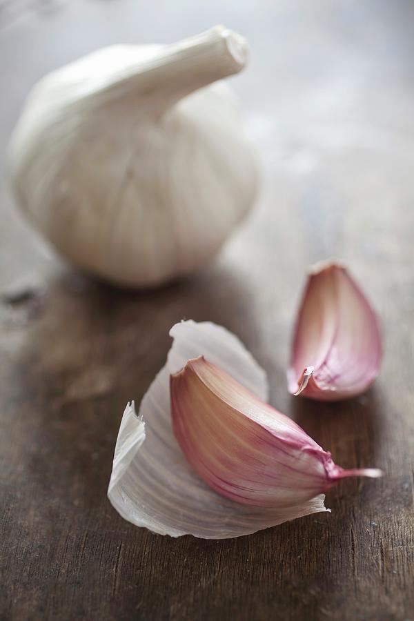 A Whole Bulb Of Garlic And Two Cloves Of Garlic Photograph by Stepien, Malgorzata