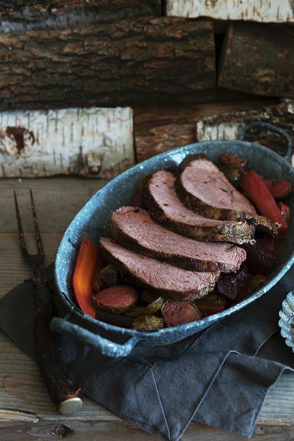 A Whole Chuck Roast, Partially Sliced On A Platter With Veggies Photograph by Veronika Studer
