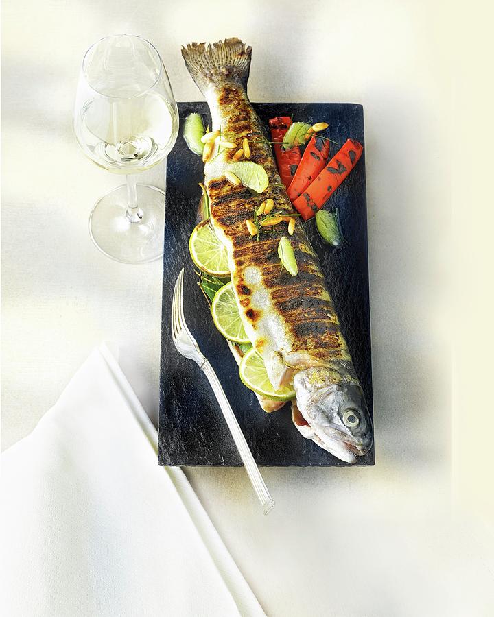 A Whole Grilled Trout Filled With Lemons Photograph by Jalag / Jan C. Brettschneider