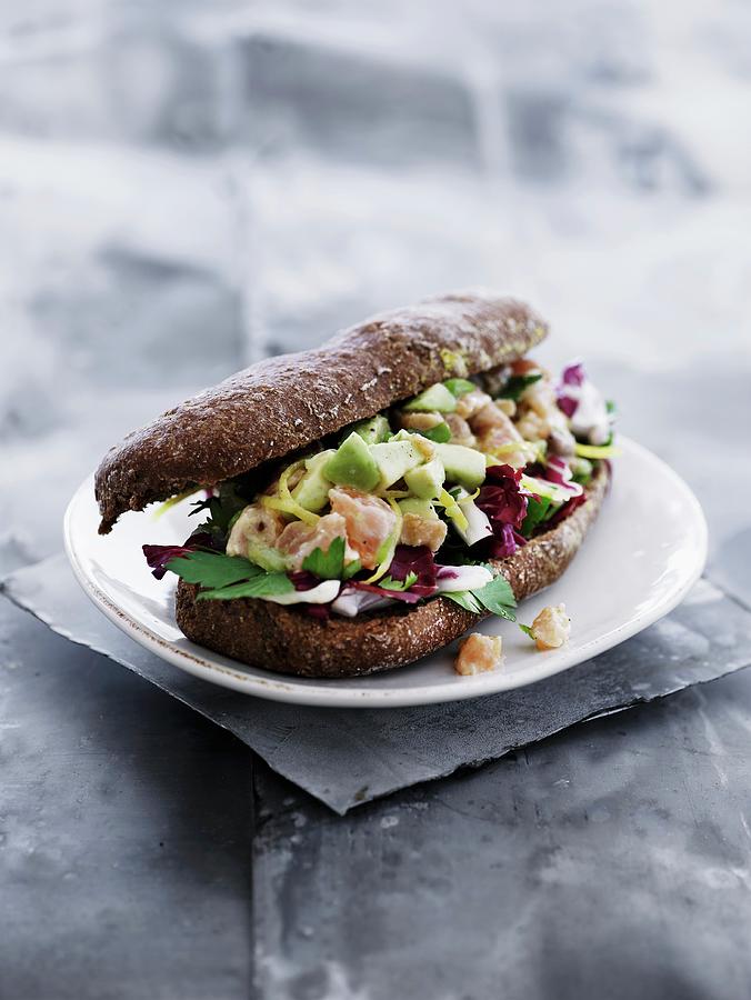 A Wholemeal Roll Filled With Salmon, Avocado And Radicchio Photograph by Mikkel Adsbl