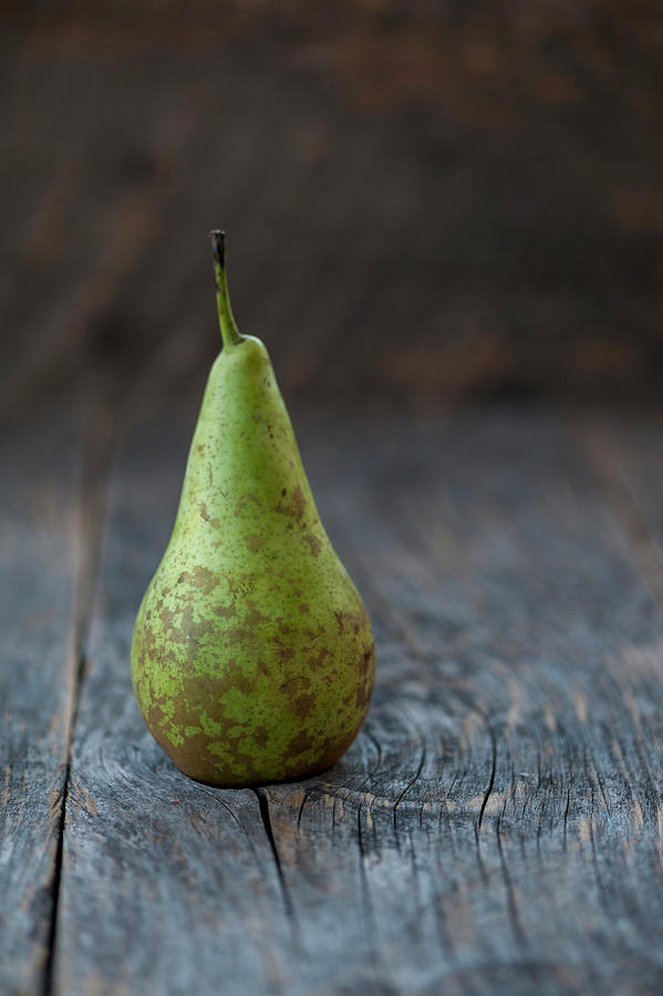 A Williams Pear On A Rustic Background Photograph by Gabriela Lupu