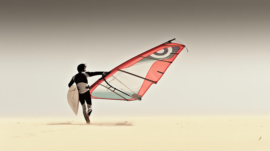 A Windsurfer Runs On The Sand Of Punta Photograph by Ben Welsh / Design Pics A Windsurfer Runs On The Sand Of Punta Photograph by Ben Welsh / Design Pics