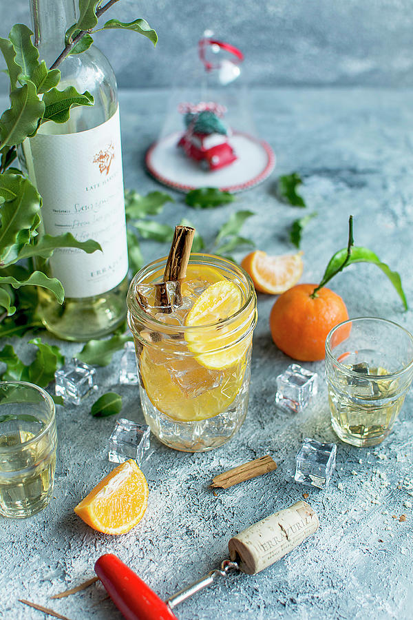 A Wine Cocktail With Tangerines, Cinnamon, And Ice Cubes Photograph by Olimpia Davies