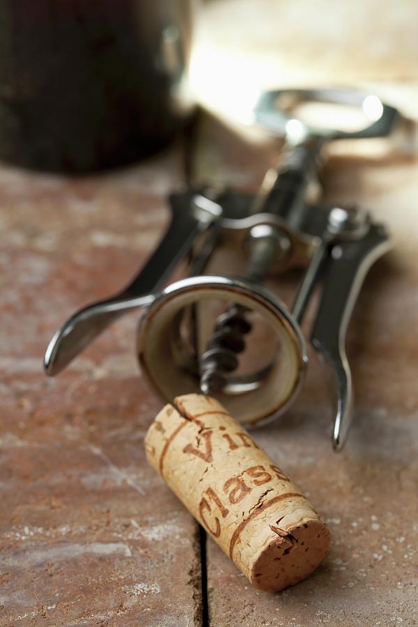 A Wine Cork With A Corkscrew And A Bottle Of Wine Photograph by Shawn Hempel