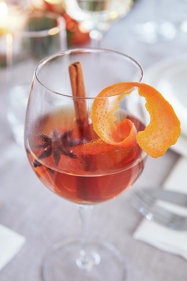 A Wine Glass Of Punch With Star Anise, A Cinnamon Stick And Orange Peel Photograph by Jalag / Olaf Szczepaniak