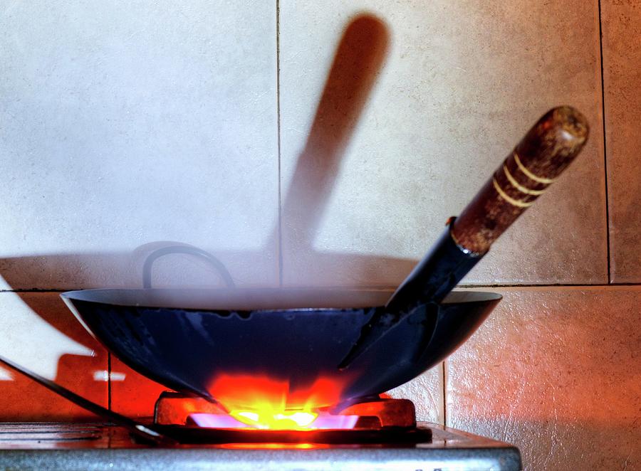 A Wok On A Gas Cooker Photograph by Kaktusfactory