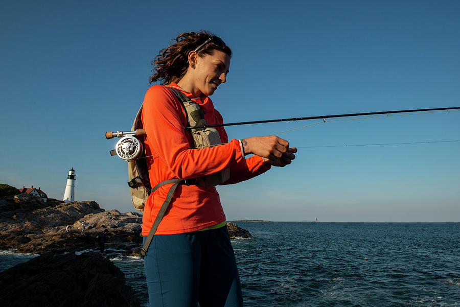 Portland Photograph - A Woman Fly Fishing In Maine. by Cavan Images
