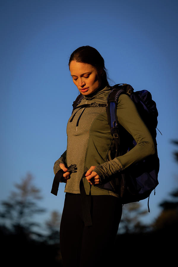 A Woman Putting On Her Backpack Photograph by Cavan Images / Joe ...