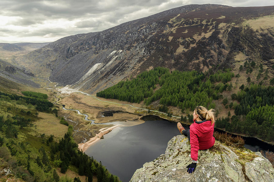 Winter Photograph - A Woman Traveler In A Red Jacket In The Spink Viewing Spot In Wicklow by Cavan Images