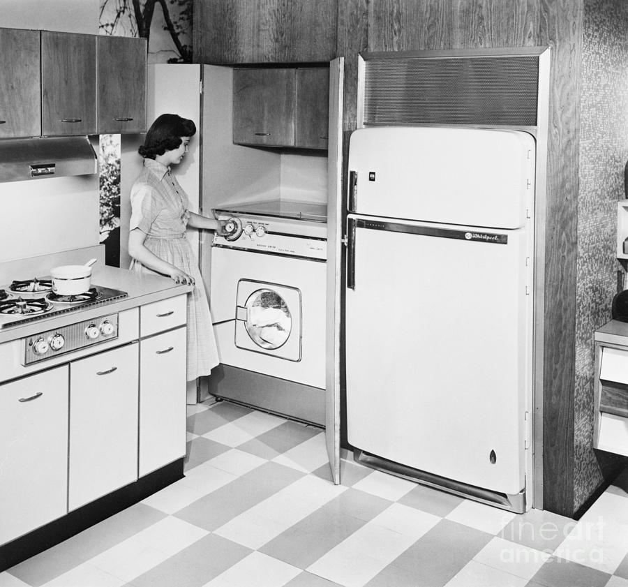 A Woman Using A Combination Washer Dryer Photograph by Bettmann