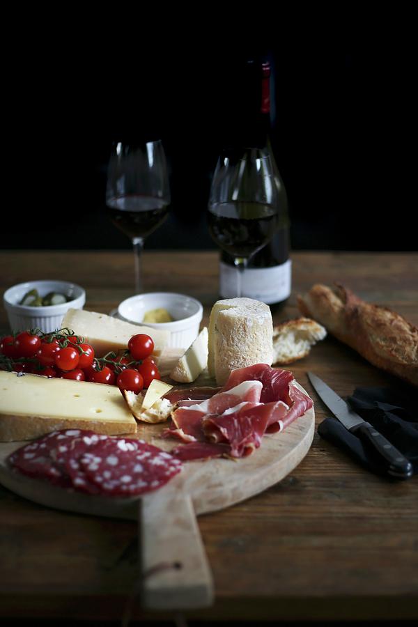 A Wooden Board With Charcuterie, Cheese, Bread And Red Wine Photograph by Eva Lambooij