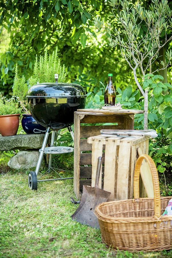 A Wooden Charcoal Grill, Wooden Boxes And A Basket In A Garden Photograph by Sebastian Schollmeyer