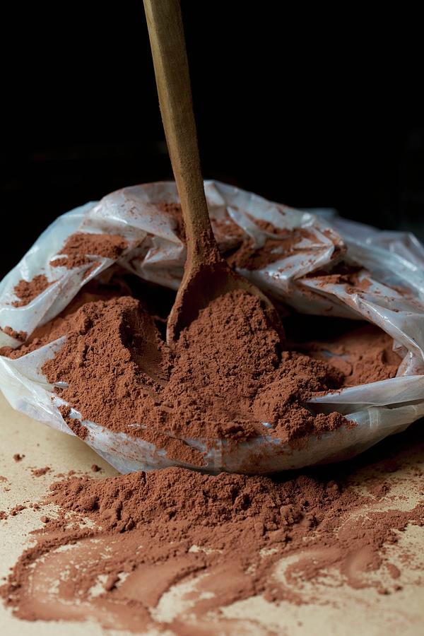 A Wooden Spoon In A Plastic Bag Of Cocoa Powder Photograph by Hilde Mche