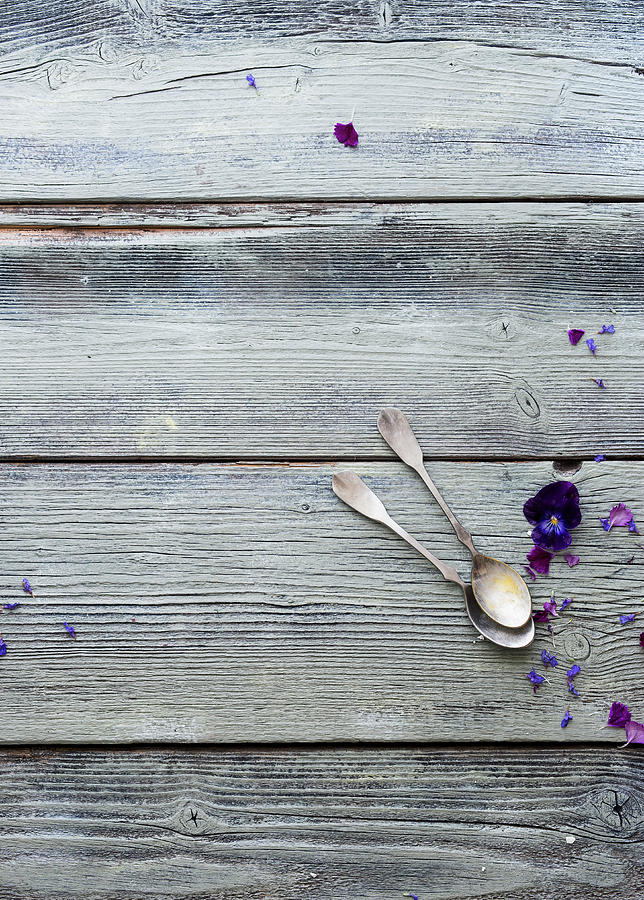 A Wooden Surface With A Vintage Teaspoons And Flowers Photograph by Ira Leoni