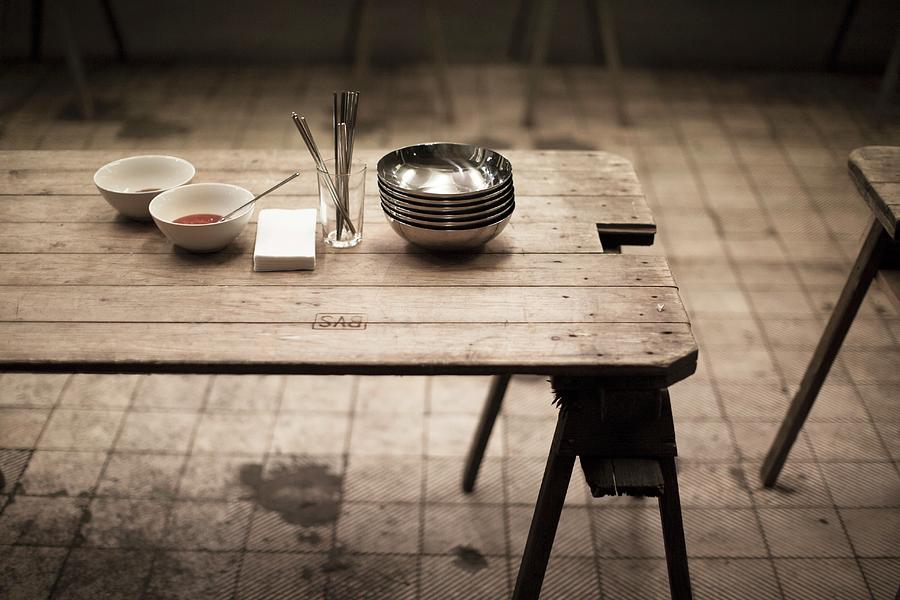 A Wooden Table And Crockery For A Schlachtfest country Feast To Eat Up Meat From Freshly Slaughtered Pigs In A Market Hall berlin Photograph by Joerg Lehmann