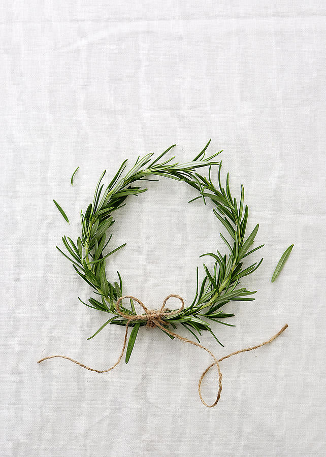 A Wreath Of Rosemary Sprigs Against A White Background Photograph by Stacy Grant