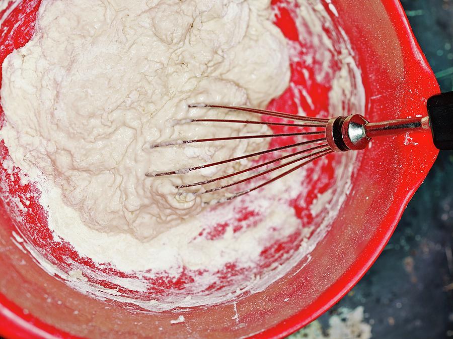 A Yeast And Water Mixture Being Stirred Into Flour For Making Yeast Dough Photograph by Foto4food