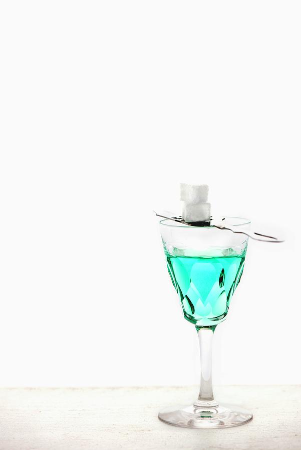 Absinthe With An Absinthe Spoon And Sugar Cubes In A Crystal Glass Photograph by Jamie Watson