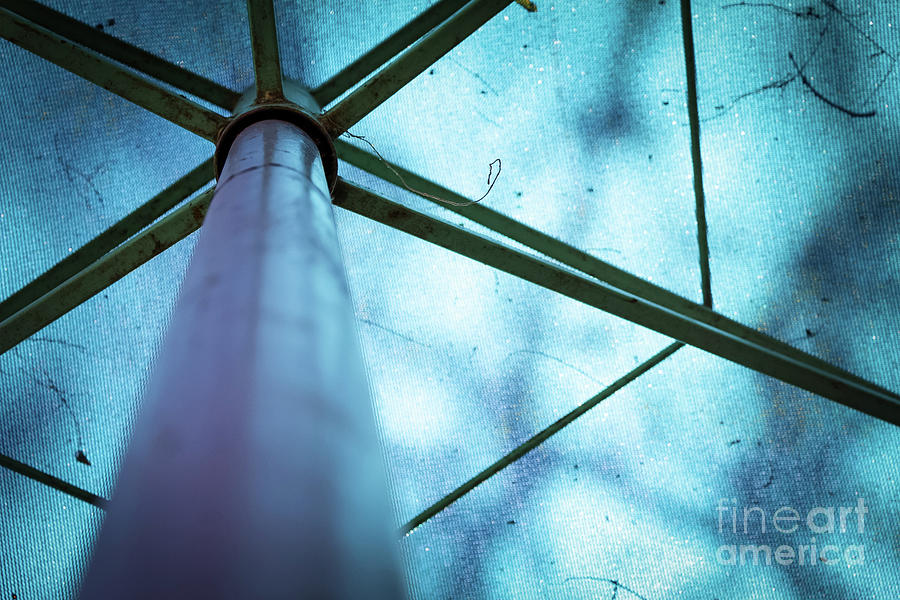 Abstract Photograph - Abstract image of a blue parasol with metal frames by Maor Winetrob