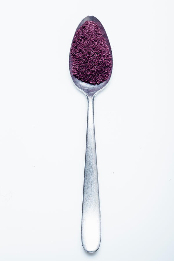 Acai Berry Powder On A Spoon Against A White Background Photograph by Eising Studio