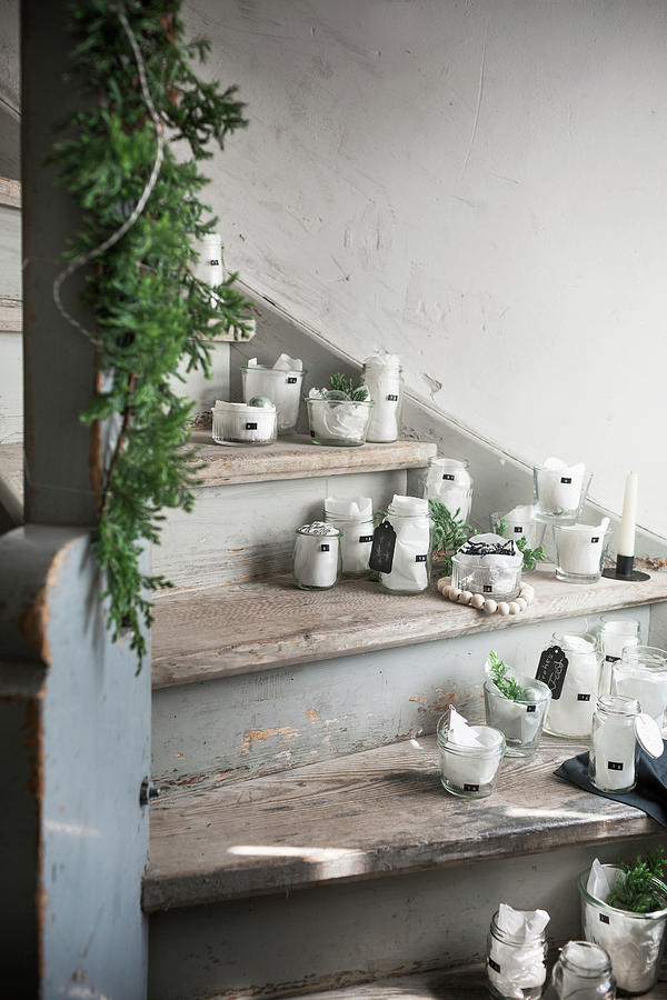 Advent Calendar Made From Jars And Tissue Paper On Stairs Photograph by Pia Simon