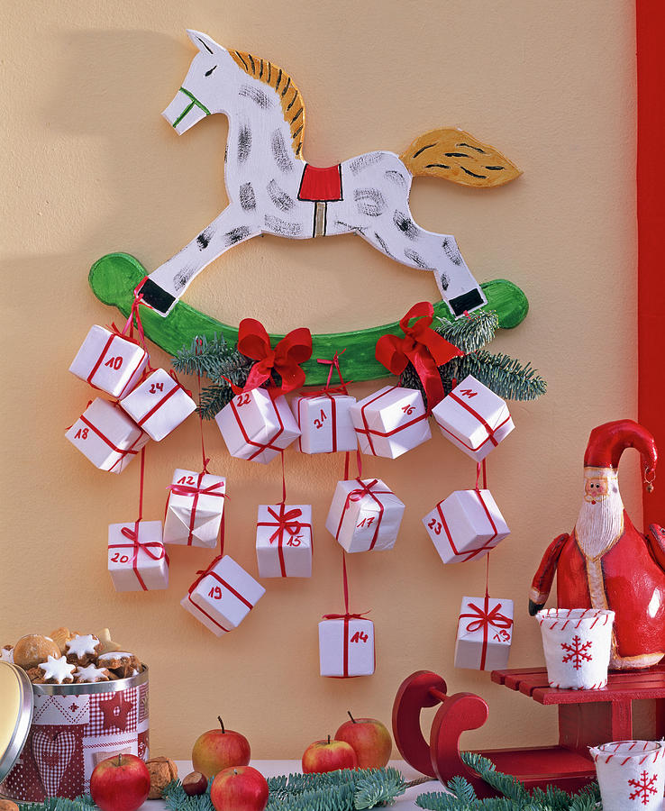 Advent Calendar Of White Parcels On Rocking Horse Photograph by Friedrich Strauss
